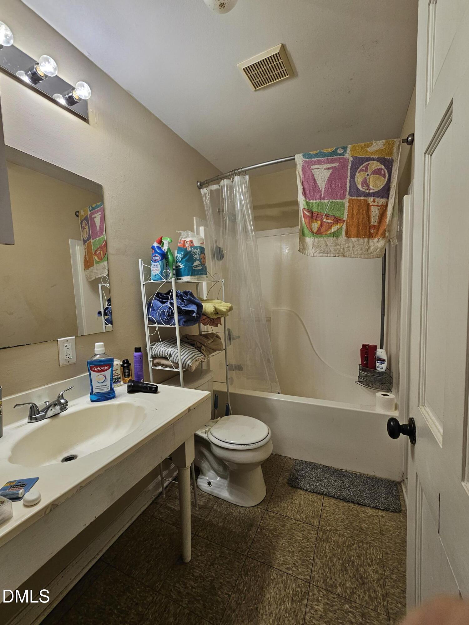 119 Lynn Drive Roxboro, NC 27573 - Photo 10 of 27 a bathroom with a sink a toilet and shower