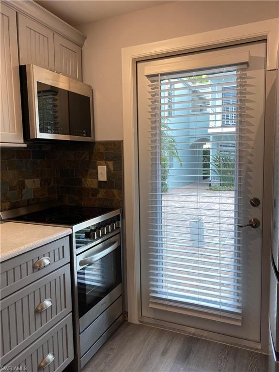 663 12th Avenue South, Unit 663 Naples, FL 34102 - Photo 3 of 5 a kitchen with a stove and a microwave