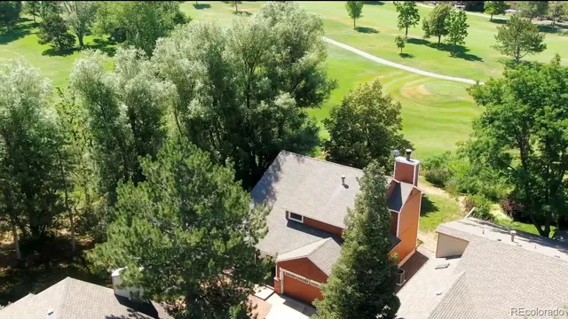 an aerial view of a house with a yard and lake view