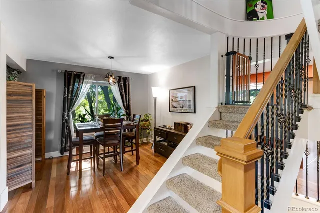 a dining room with furniture and wooden floor