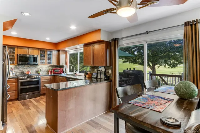 a view of a kitchen with kitchen island granite countertop a large window