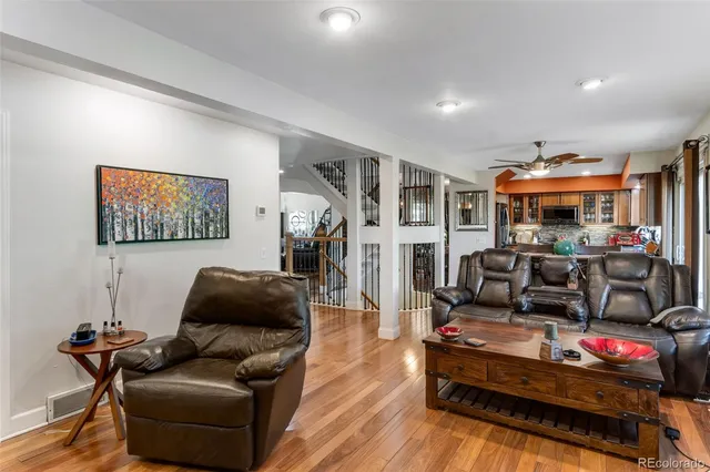a living room with furniture a wooden floor and a table
