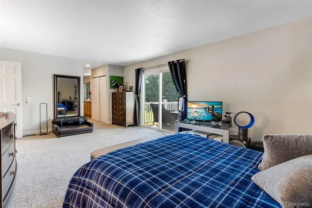 a bedroom with bed and a large window