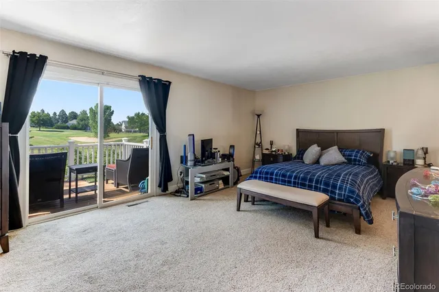 a spacious bedroom with a bed and large windows