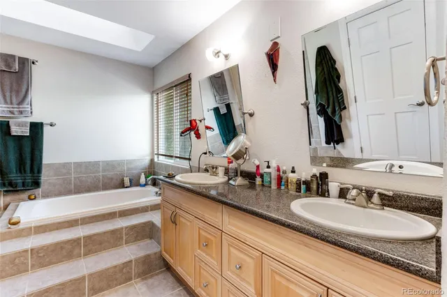 a bathroom with double vanity sinks a mirror and a shower