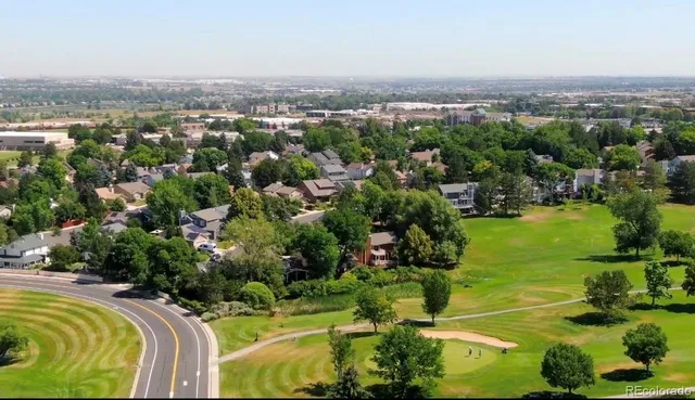an aerial view of residential houses with outdoor space and swimming pool