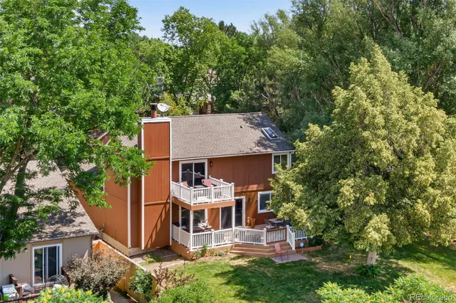 an aerial view of a house with a yard table and chairs