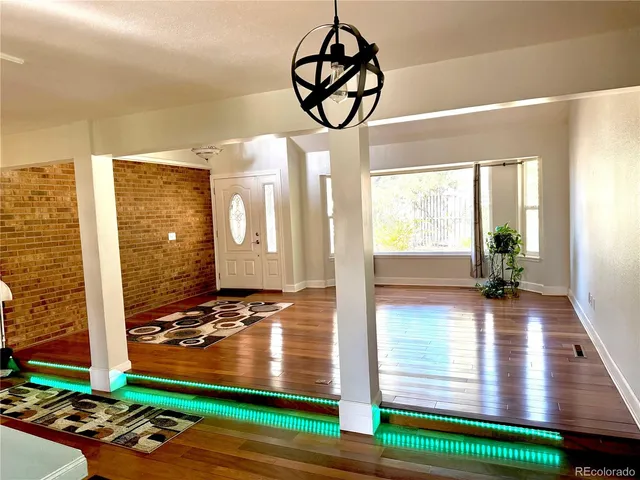 a view of an entryway with wooden floor