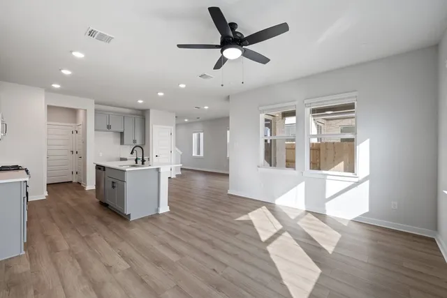 a view of kitchen with sink microwave and refrigerator