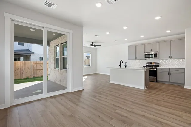 a view of kitchen with cabinets and wooden floor