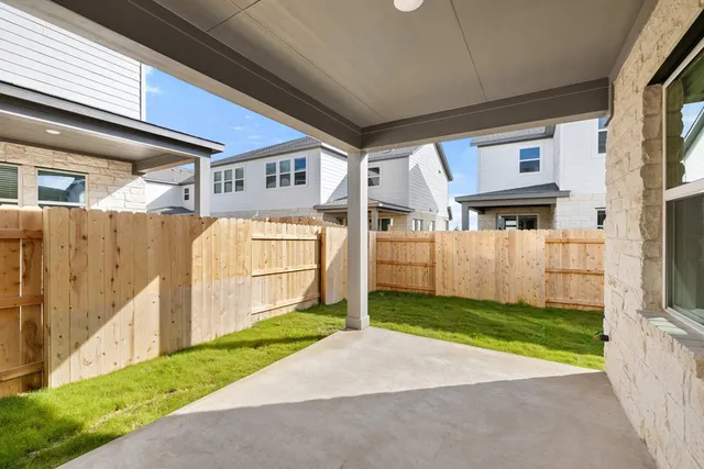 a view of a brick house with a yard