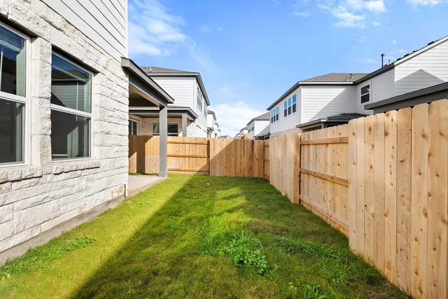 a view of house with backyard and deck