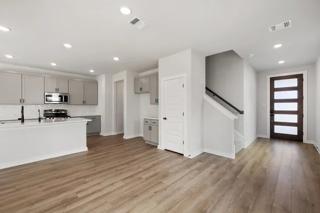 a view of kitchen with wooden floor and electronic appliances