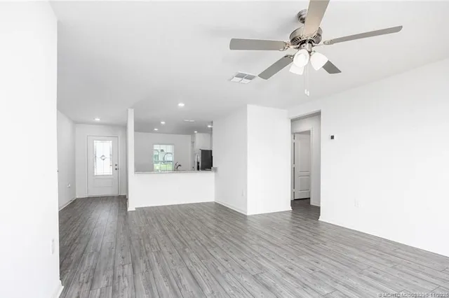 a view of an empty room and wooden floor