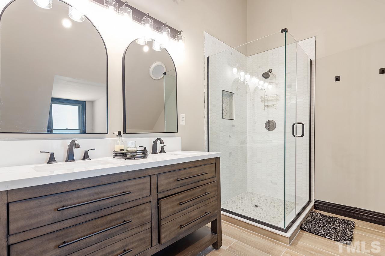 11804 Old Creedmoor Road Raleigh, NC 27613 - Photo 28 of 36 a bathroom with a double vanity sink mirror and double