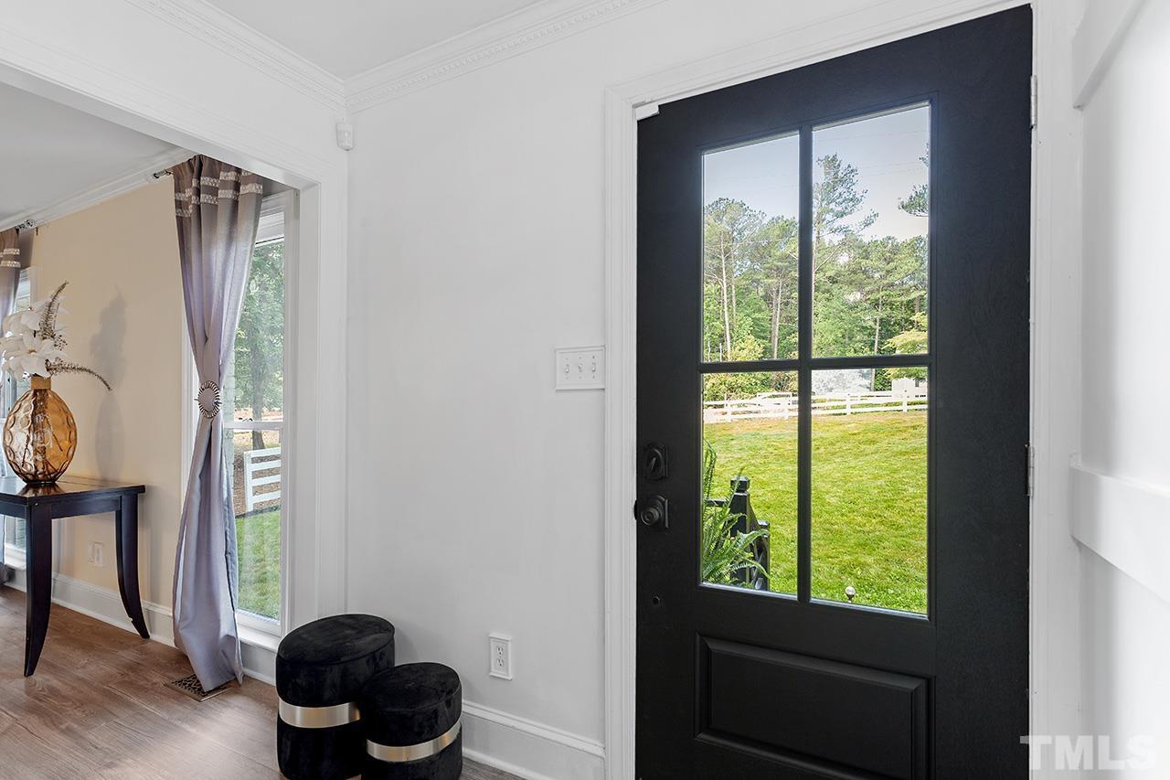 11804 Old Creedmoor Road Raleigh, NC 27613 - Photo 4 of 36 a room with a window and a potted plant