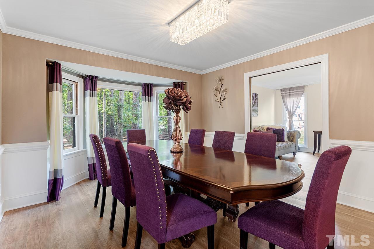 11804 Old Creedmoor Road Raleigh, NC 27613 - Photo 10 of 36 a view of a dining room with furniture window and wooden floor