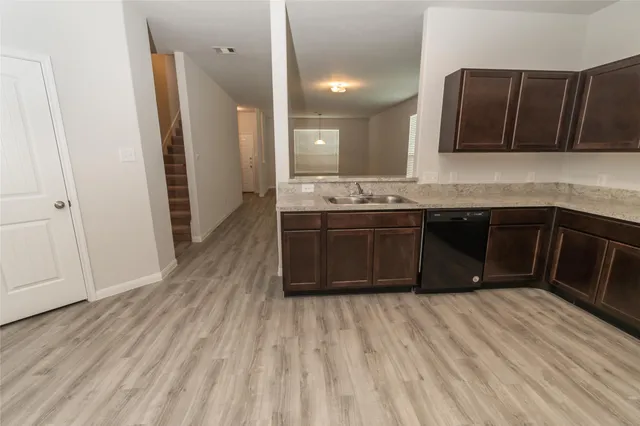 a kitchen with a sink and a stove top oven