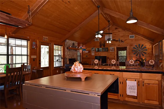 a room with furniture a chandelier and pool table