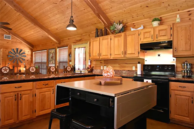 a kitchen with a sink stove and cabinets