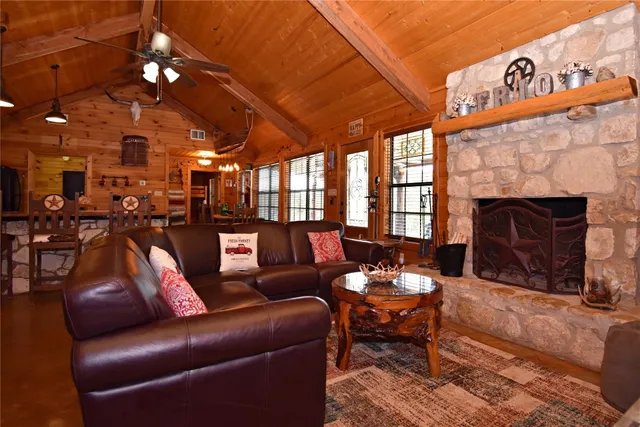 a living room with furniture a fireplace and a chandelier