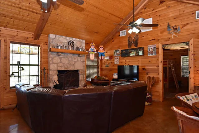 a living room with furniture a flat screen tv and a fireplace