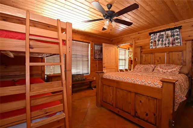 a spacious bedroom with a large bed and a chandelier