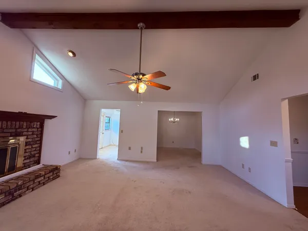 a view of an empty room with a fireplace