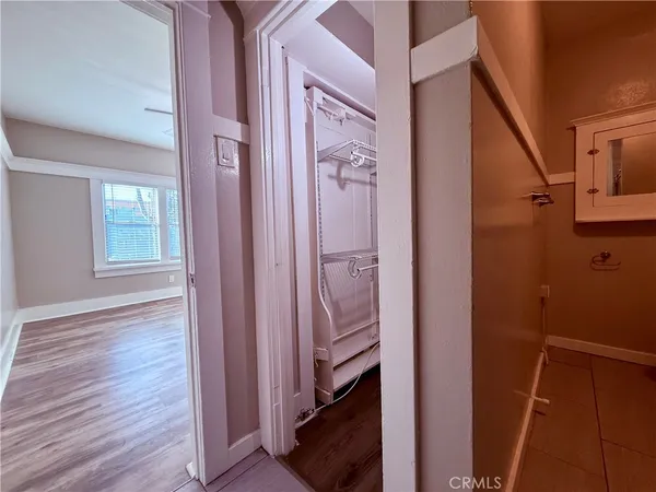 a view of a hallway with wooden floor and entryway