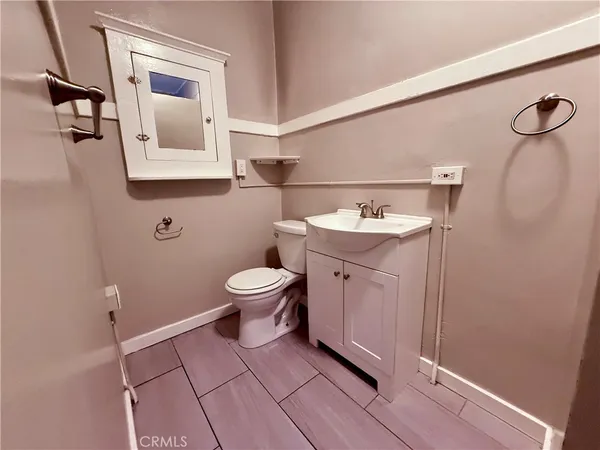 a bathroom with a sink toilet and mirror