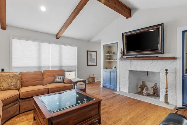 a living room with fireplace furniture and a flat screen tv