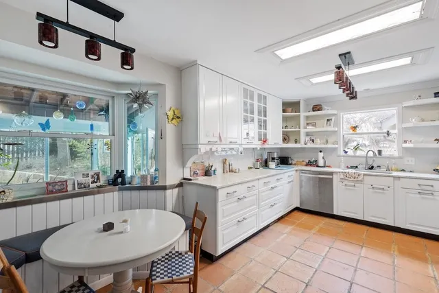 a kitchen with stainless steel appliances a stove and cabinets