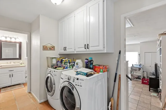 a work room with furniture a flat screen tv and a window
