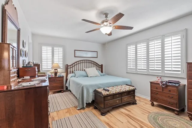 a bathroom with a double vanity sink toilet mirror and shower