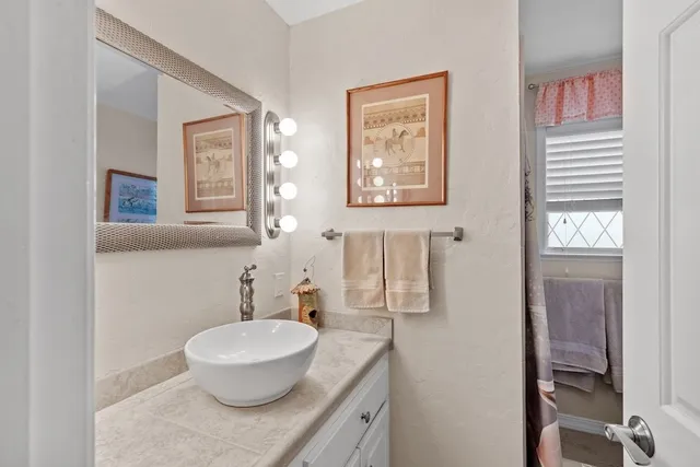a bathroom with a granite countertop sink a toilet and a bathtub