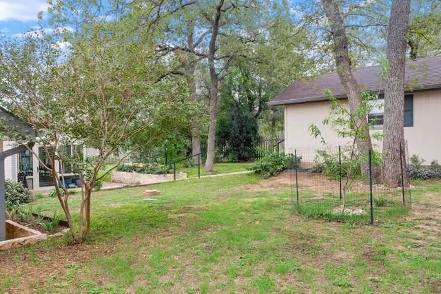 a front view of a house with a yard and potted plants