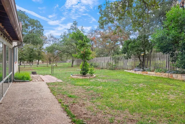 a view of house with a backyard space