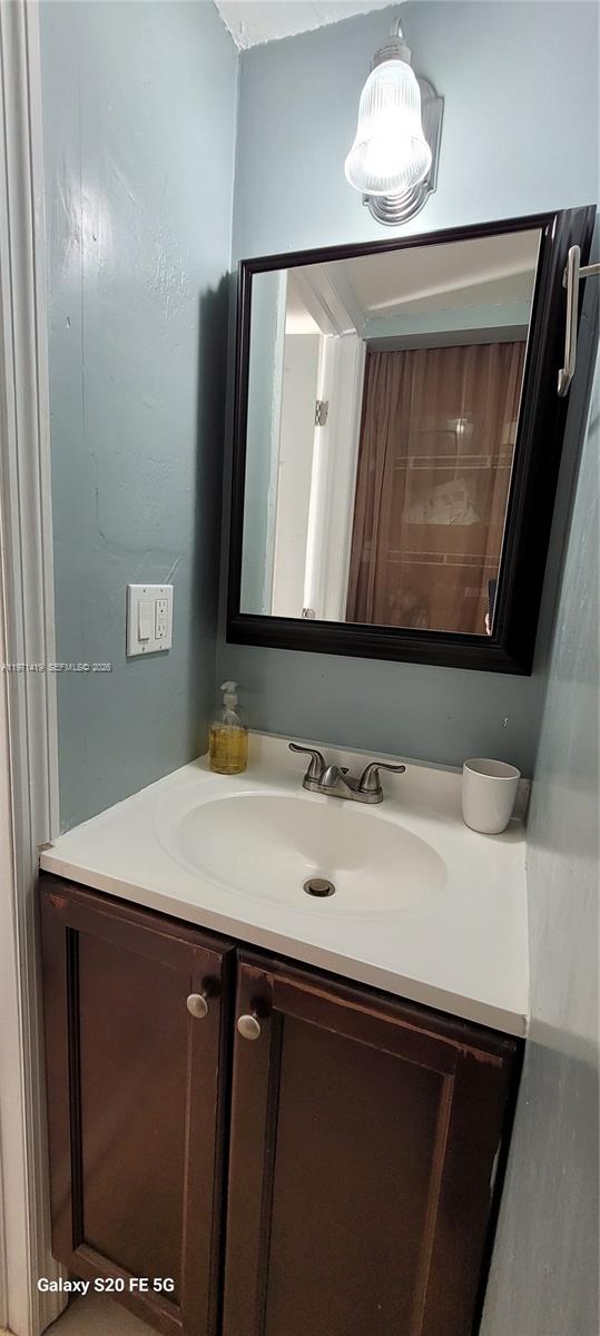 4036 Southwest 67th Terrace, Unit 5 Davie, FL 33314 - Photo 12 of 21 a bathroom with a sink and a mirror