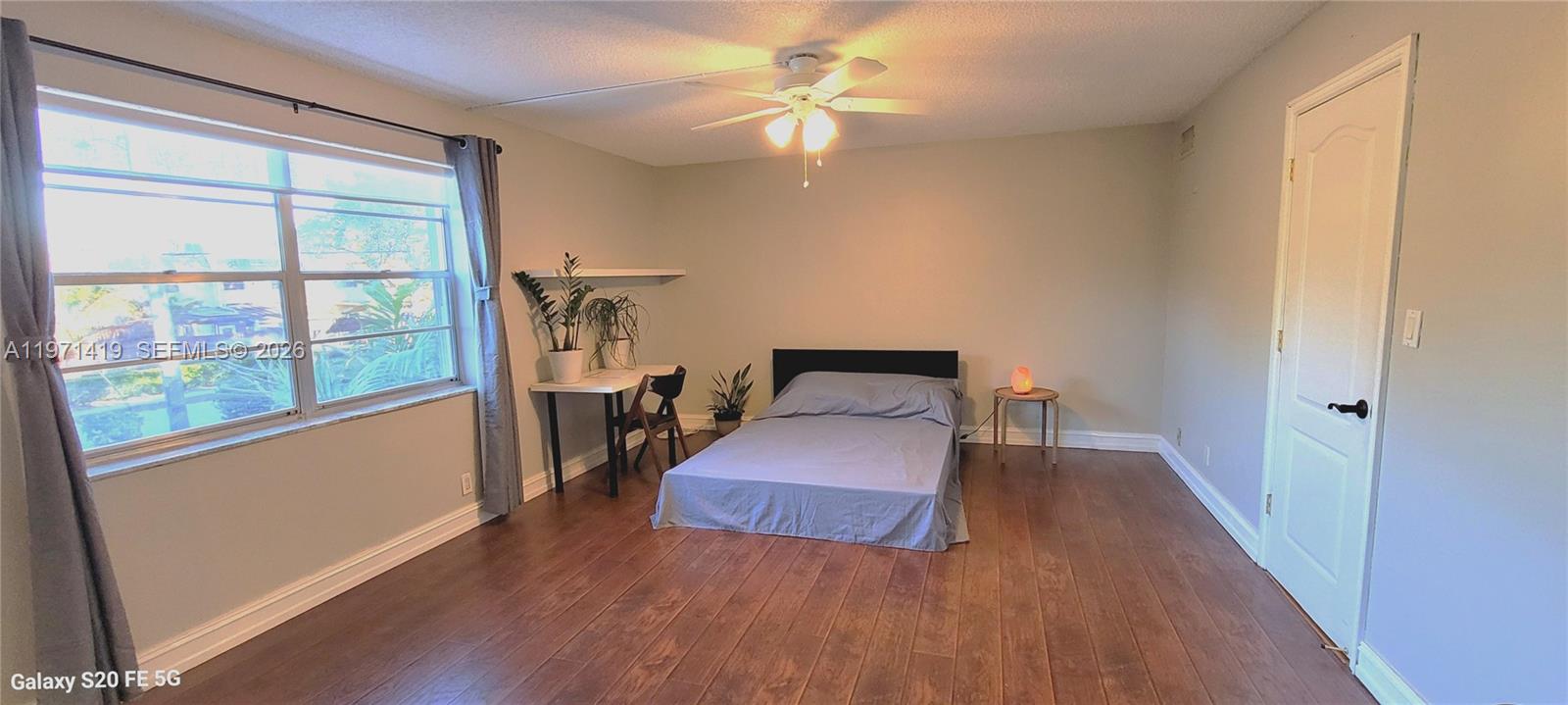 4036 Southwest 67th Terrace, Unit 5 Davie, FL 33314 - Photo 15 of 21 a bedroom with wooden floor and a bed