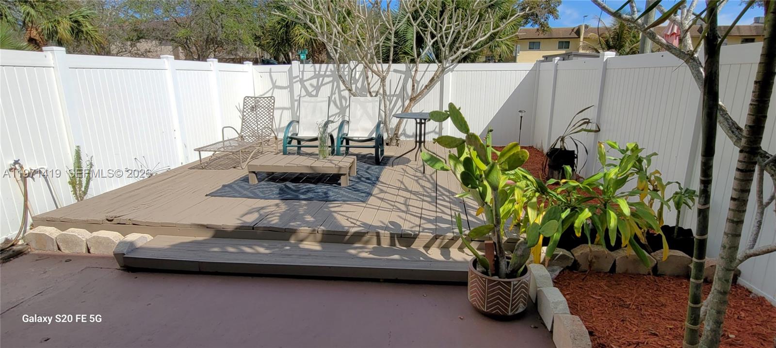 4036 Southwest 67th Terrace, Unit 5 Davie, FL 33314 - Photo 16 of 21 a picture of table and chairs with potted plants