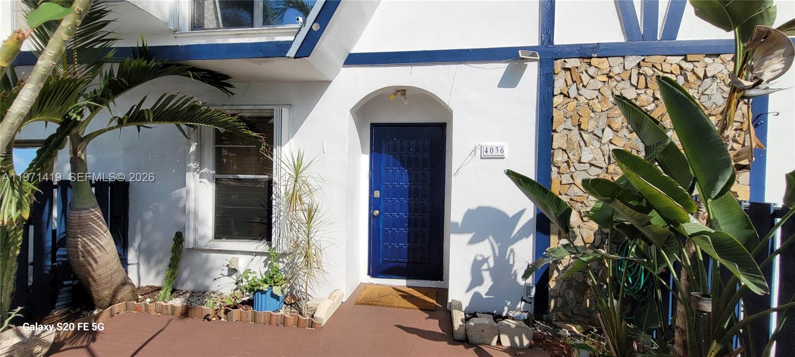 4036 Southwest 67th Terrace, Unit 5 Davie, FL 33314 - Photo 2 of 21 a view of a entryway with flower pots
