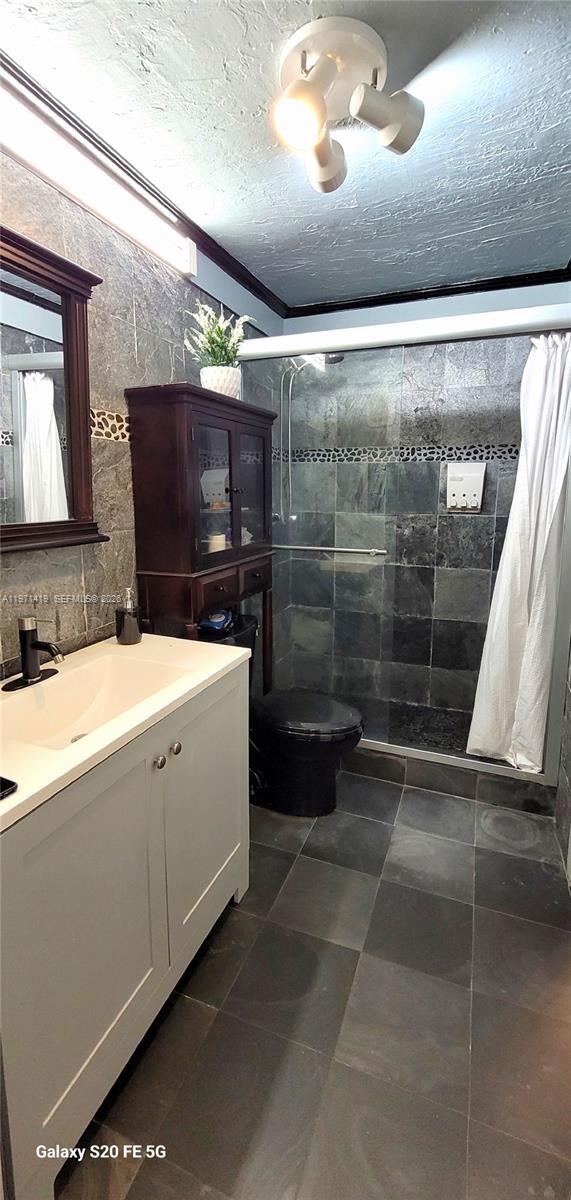 4036 Southwest 67th Terrace, Unit 5 Davie, FL 33314 - Photo 10 of 21 a bathroom with a sink a toilet a mirror and shower