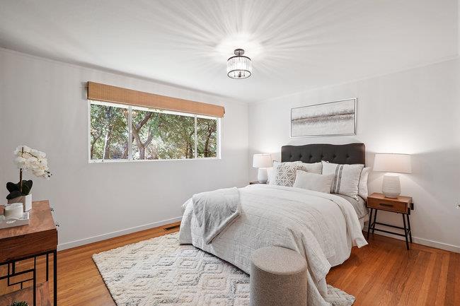 3324 Woodside Road Woodside, CA 94062 - Photo 21 of 60 a bedroom with a bed and a wooden floor
