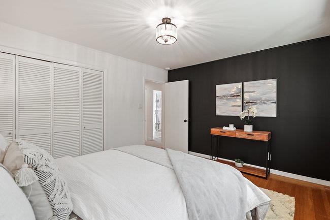 3324 Woodside Road Woodside, CA 94062 - Photo 22 of 60 a bedroom with a bed and a chandelier