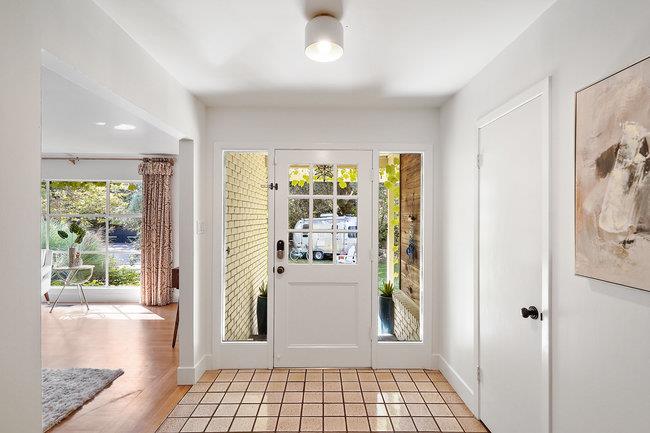 3324 Woodside Road Woodside, CA 94062 - Photo 9 of 60 a view of a hallway with wooden floor and a dining room