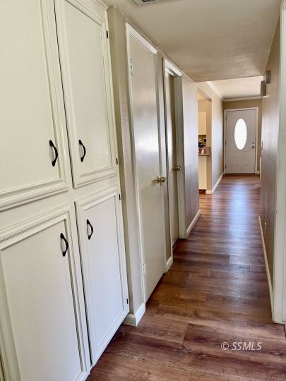 401 South Lincoln Street Ridgecrest, CA 93555 - Photo 13 of 27 a view of a hallway with wooden floor and staircase