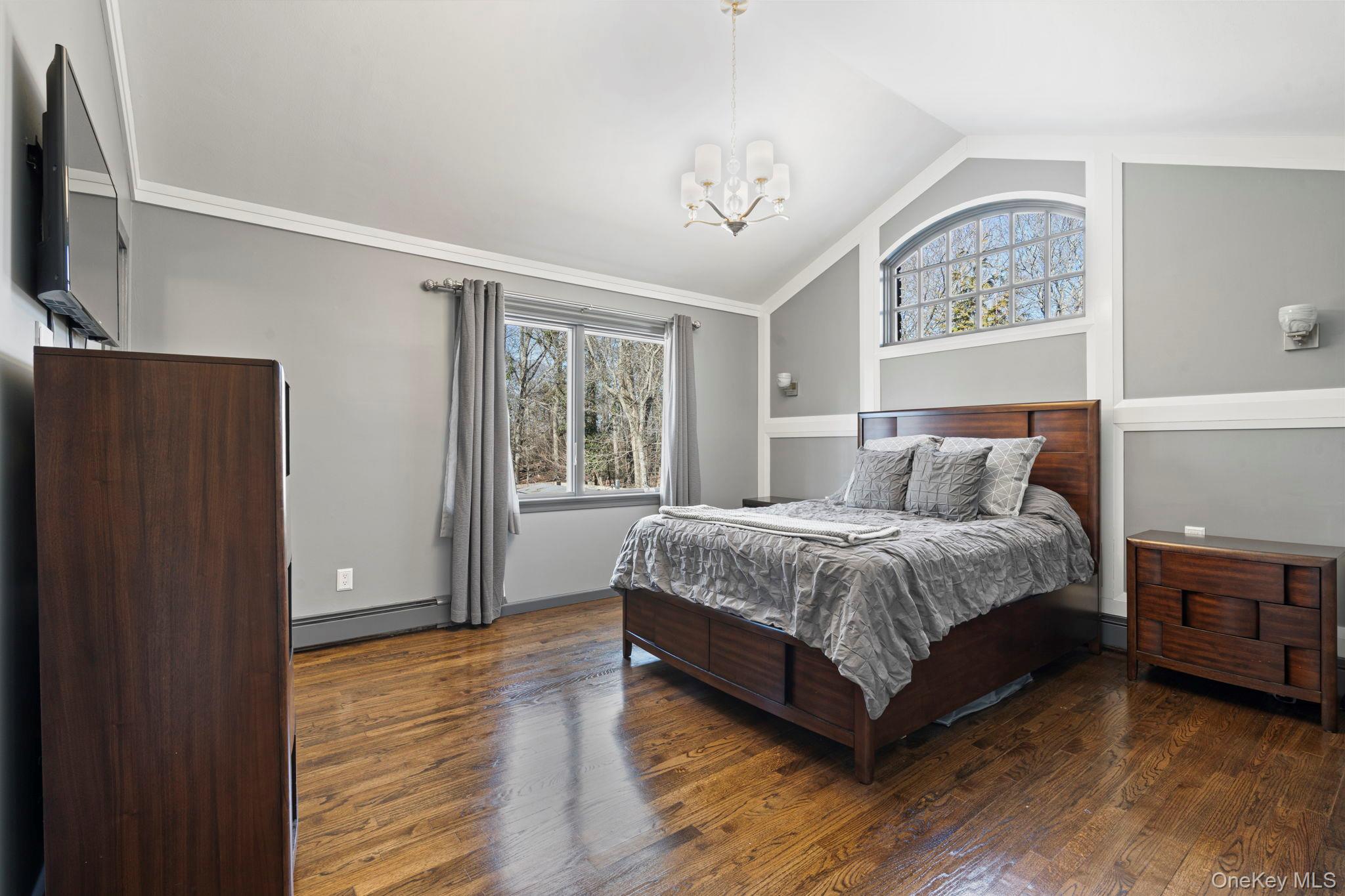 25 Cliff Road West Wading River, NY 11792 - Photo 12 of 35 a spacious bedroom with a bed and a window
