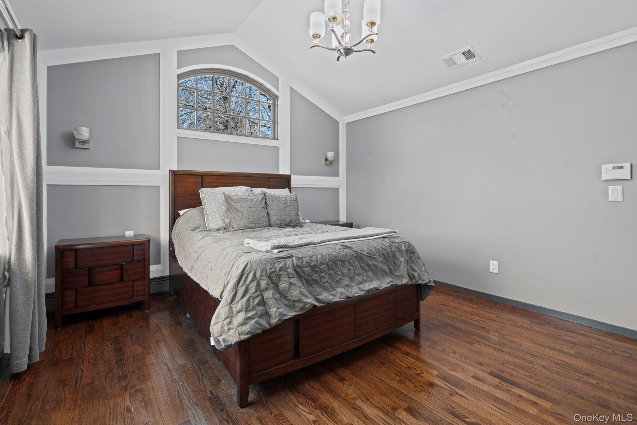 25 Cliff Road West Wading River, NY 11792 - Photo 14 of 35 a bed sitting in a bedroom next to a window