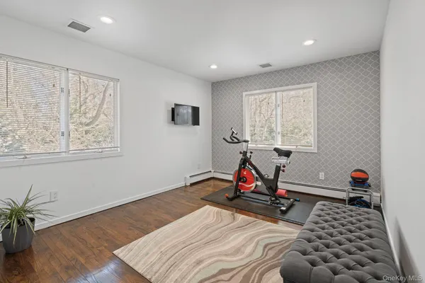 a view of a room with gym equipment and a window
