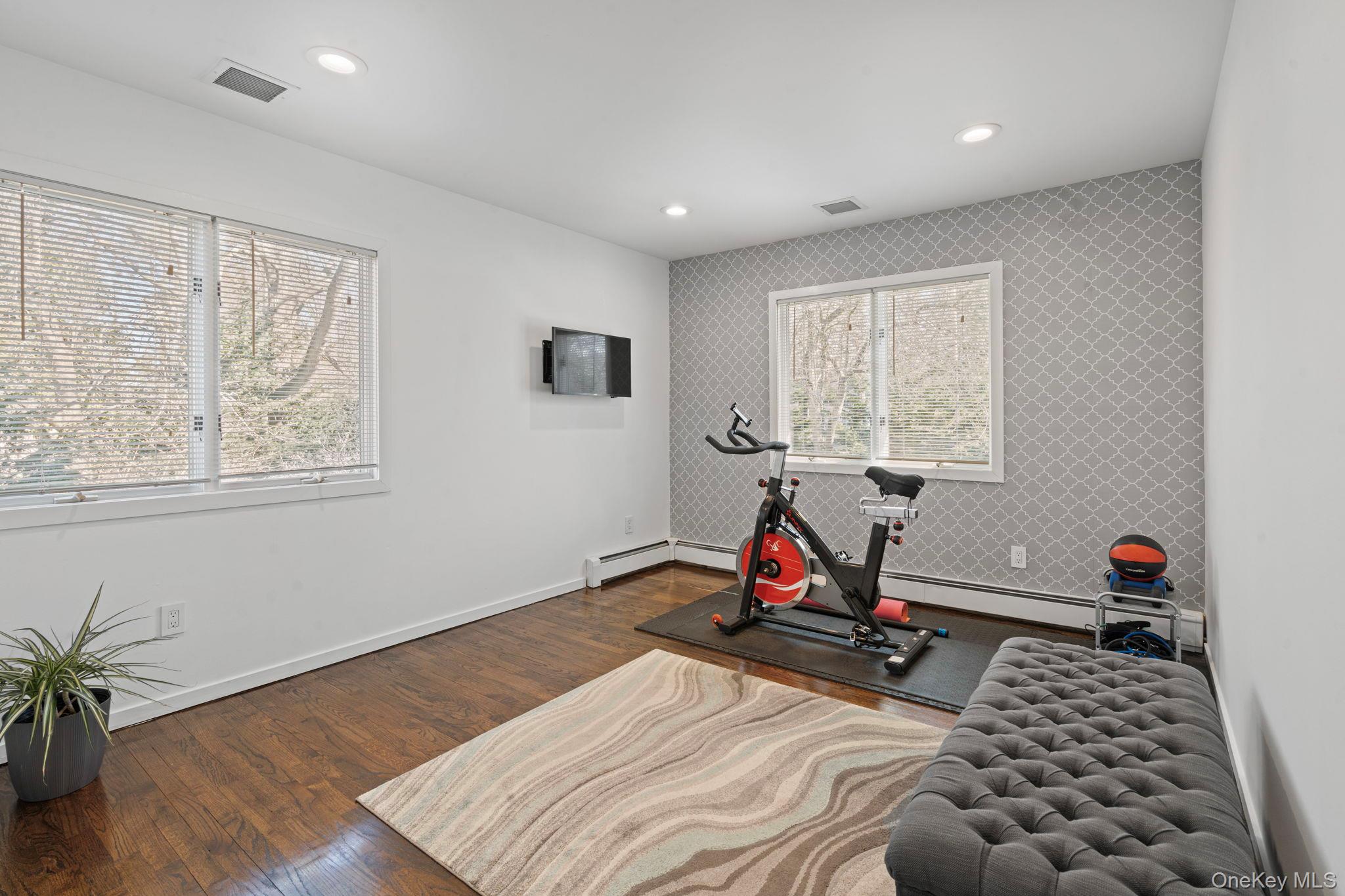 25 Cliff Road West Wading River, NY 11792 - Photo 16 of 35 a view of a room with gym equipment and a window